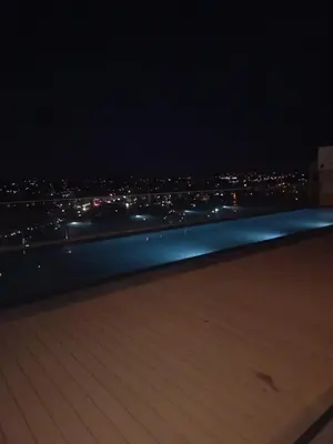 a view of a city at night from a rooftop at Menlyn Maine Trilogy Apartment 808 in Pretoria