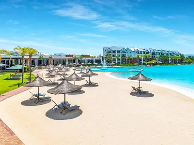 a beach with chairs and umbrellas next to the water at 1368 The Blyde Crystal Clear 1 Bedroom Apartment in Pretoria