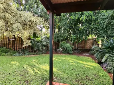 a yard with a fence and a pole in the grass at The Grace in Pretoria