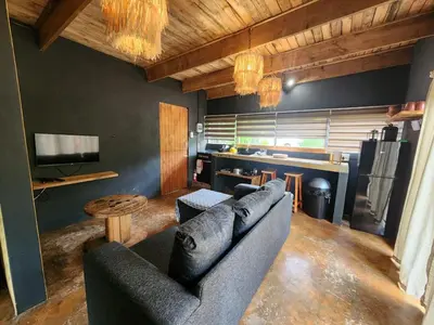 a living room with a couch and a table at Hartbeest Bush Stay #4 in Hartbeespoort