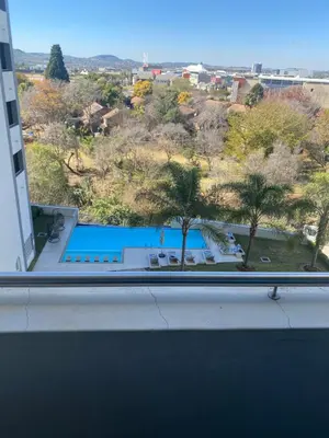 a view of a swimming pool from the window of a building at Luxurious Resorts in Pretoria