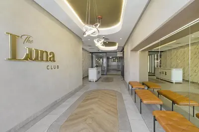 a waiting room with benches and a sign on the wall at Ellipse Waterfall 31002 in Midrand