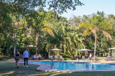 a group of people walking around a swimming pool at Kruger Park Lodge Unit No. 524 in Hazyview