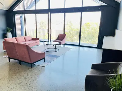 a living room with two couches and a table at Secure 1 Bedroom Apartment in Midrand, Waterfall City - Lock Up and Go - Free WIFI and Parking - 5 Elizabeth Place in Midrand