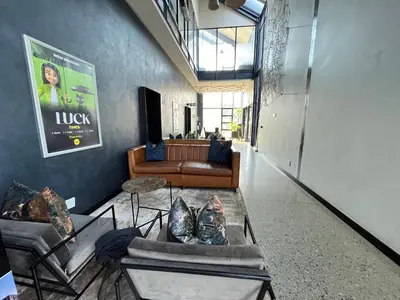 a living room with couches and a couch at Secure 1 Bedroom Apartment in Midrand, Waterfall City - Lock Up and Go - Free WIFI and Parking - 7 Elizabeth Place in Midrand