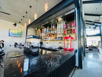 a bar in a restaurant with a red refrigerator at Secure 1 Bedroom Apartment in Midrand, Waterfall City - Lock Up and Go - Free WIFI and Parking - 7 Elizabeth Place in Midrand