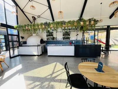 a restaurant with tables and chairs in a room at Secure 1 Bedroom Apartment in Midrand, Waterfall City - Lock Up and Go - Free WIFI and Parking - 7 Elizabeth Place in Midrand