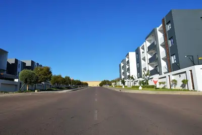 an empty street in front of a building at Elcaro Luxury Villas-Urban Taupe in Midrand