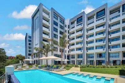an image of an apartment building with a swimming pool at Premier Lifestyle at The Regency in Pretoria