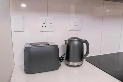 a toaster and a toaster sitting on a counter at Secure 1 Bedroom Apartment in Midrand, Waterfall City - Lock Up and Go - Free WIFI and Parking - 8 Elizabeth Place in Midrand