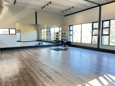 an empty room with a wooden floor and windows at Secure 1 Bedroom Apartment in Midrand, Waterfall City - Lock Up and Go - Free WIFI and Parking - 8 Elizabeth Place in Midrand