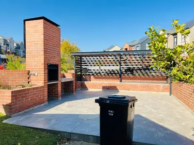 a trash can sitting in the middle of a patio at 10 Elizabeth Place - Beautiful self catering 2 bedroom unit next to Kyalami Racetrack with free WiFi swimming pool gym and restaurant - Perfect for a small family in Midrand Waterfall in Midrand