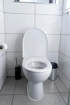 a white toilet in a white tiled bathroom at Large 3 Bedroom Apartment in Midrand, Waterfall City - More space than a hotel room - Ideal for families, groups and work trips - 19 Elizabeth Place in Midrand
