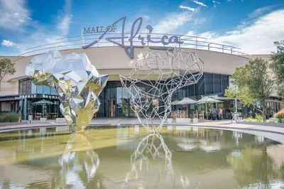 a sculpture in the water in front of a building at Mamuka Africa in Midrand