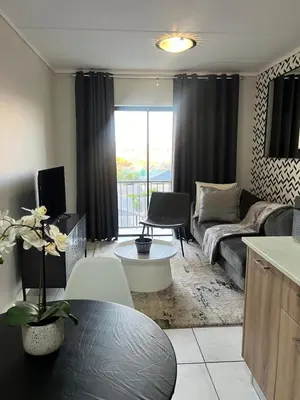 a living room with a couch and a table at The Green Lifestyle Apartments in Pretoria