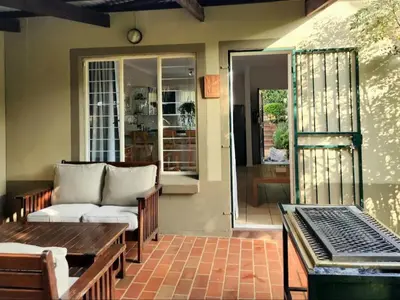 a living room with a couch and a table at Selah, self-catering in Pretoria