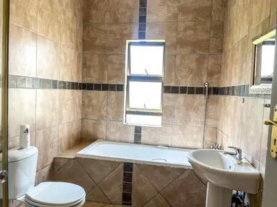 a bathroom with a tub and a toilet and a sink at Bobisemo Lux Guesthouse in Tierpoort