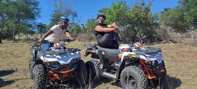 a man and a woman sitting on two atvs at Casa de la Presa 6 in Polokwane