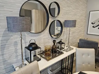 a living room with mirrors on the wall at Capital Trilogy Apartments in Pretoria