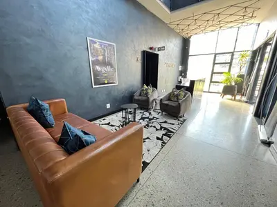 a living room with a couch and two chairs at Large 3 Bedroom Apartment in Midrand, Waterfall City - More space than a hotel room - Ideal for families, groups and work trips - 18A Elizabeth Place in Midrand