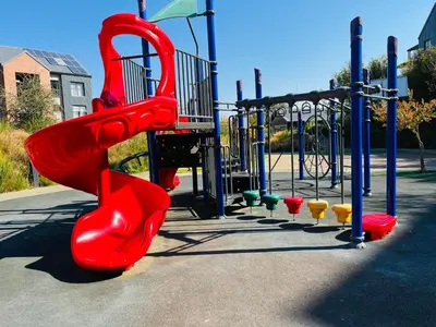 a playground with a red slide in a park at Large 3 Bedroom Apartment in Midrand, Waterfall City - More space than a hotel room - Ideal for families, groups and work trips - 18A Elizabeth Place in Midrand