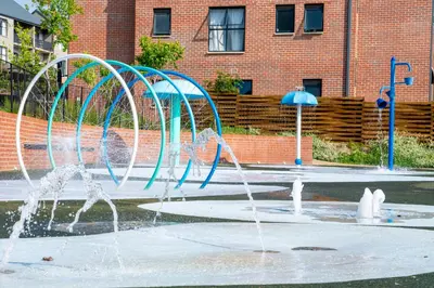 a group of water fountains in front of a building at Spacious 2 Bedroom Apartment in Midrand, Waterfall City - Business and Family friendly - 14A Elizabeth Place in Midrand