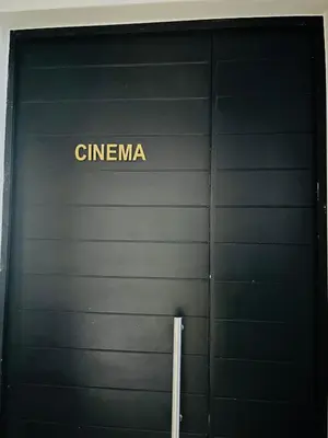 a black garage door with the word cinema on it at Secure 1 Bedroom Apartment in Midrand, Waterfall City - Lock Up and Go - Free WIFI and Parking - 6A Elizabeth Place in Midrand