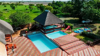 an overhead view of a swimming pool with a pavilion at Falcon Lodge Bela Bela in Merinovlakte