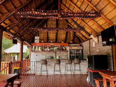 an outdoor bar with bar stools in a building at Falcon Lodge PK in Bela-Bela