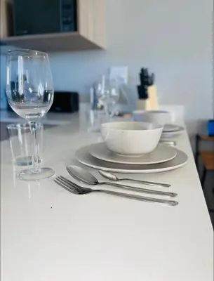 a table with a plate and a bowl and a glass at Dubai 8 in Midrand