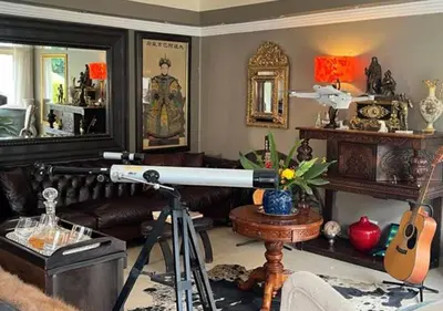 a living room with a telescope in a room at The Flamingo Suite at Frederick's Place in Pretoria