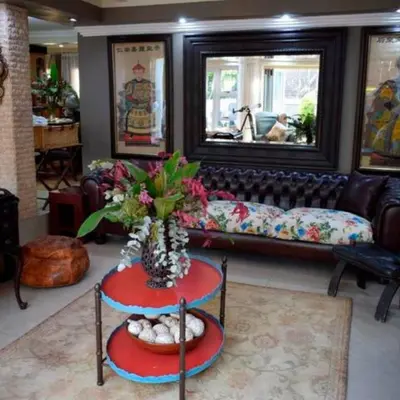 a living room with a couch and a table at The Rhino Room at Frederick's Place in Pretoria