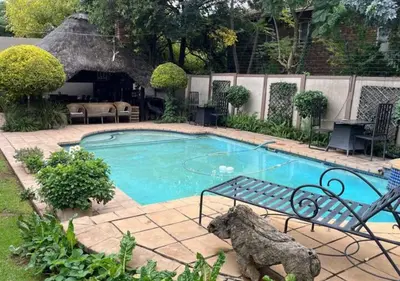 a small swimming pool with a bench next to it at The Rhino Room at Frederick's Place in Pretoria