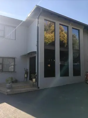 a white house with large glass windows on it at Choosers Express Boutique Hotel Room 4 in Centurion