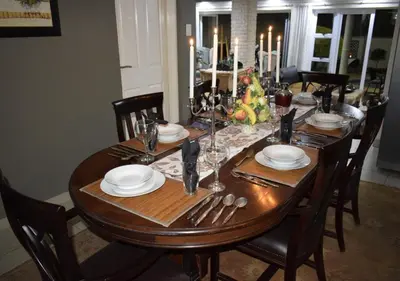 a dining room table with a christmas tree on it at The Zebra Suite at Frederick's Place in Pretoria
