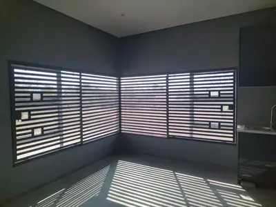a room with two large windows with blinds at Zinnia house in Midrand