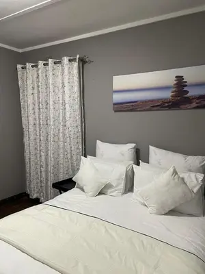 a large white bed with white pillows in a bedroom at Palma de Mallorca in Kempton Park