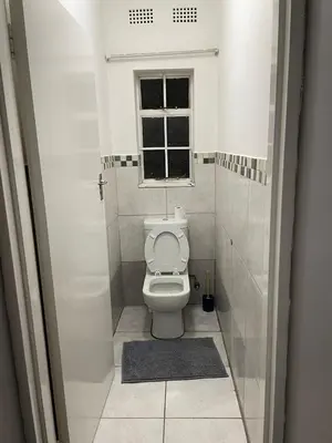 a small bathroom with a toilet and a window at Palma de Mallorca in Kempton Park
