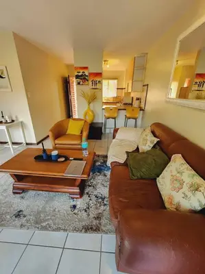 a living room with a couch and a table at 2d - 50 No load shedding - 2 bedroom in Centurion