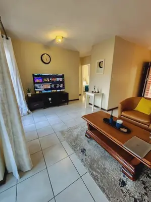 a living room with a couch and a coffee table at 2b - 74 No load shedding - 2 bed home in Centurion