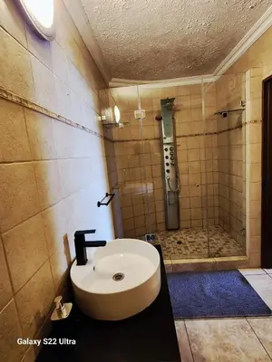 a bathroom with a sink and a shower at Lake View in Hartbeespoort