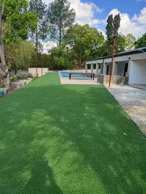 a large grassy yard with a skate park in the background at Limewood Pool view in Sandton