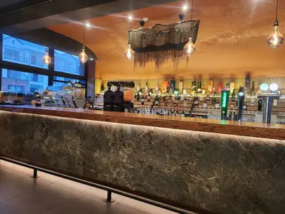 a bar in a restaurant with a lot of liquor bottles at Cozy home at The Blyde in Pretoria