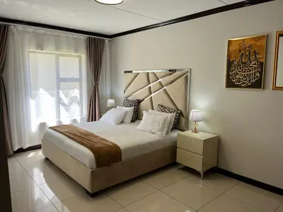 a bedroom with a large bed and a window at Lake view Apartment in Midrand