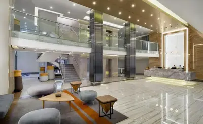 a large lobby with chairs and tables in a building at 522 The Regency Menlyn in Pretoria