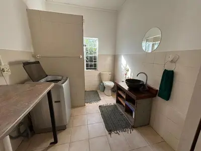 a bathroom with a sink and a toilet and a mirror at The Seed Pod Guesthouse in Haningfontein