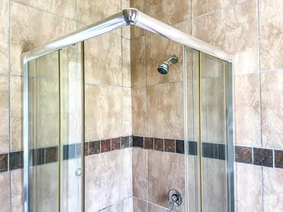 a shower with a glass door with a shower head at Bobisemo Luxury Guesthouse in Tierpoort