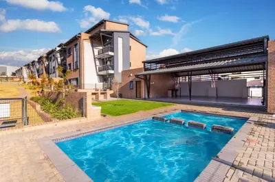 a swimming pool in front of a building at Diamond Hill in Midrand