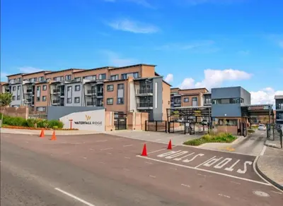 an empty parking lot in front of a building at Diamond Hill in Midrand