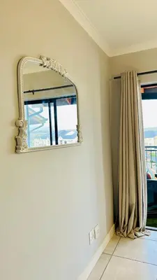 a mirror on a wall in a room with a window at House of sebo in Pretoria